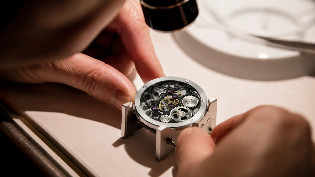 Watchmaker servicing a HORAE V mechanical watch movement