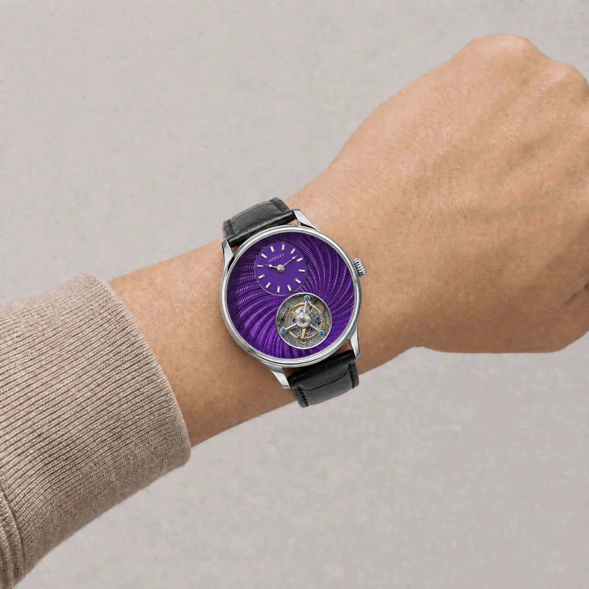 HOREAV silver tourbillon watch worn on wrist with purple guilloche-style dial and black leather strap