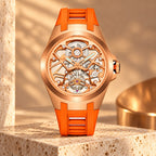 T306M rose gold tone tourbillon with orange strap in a warm stone scene